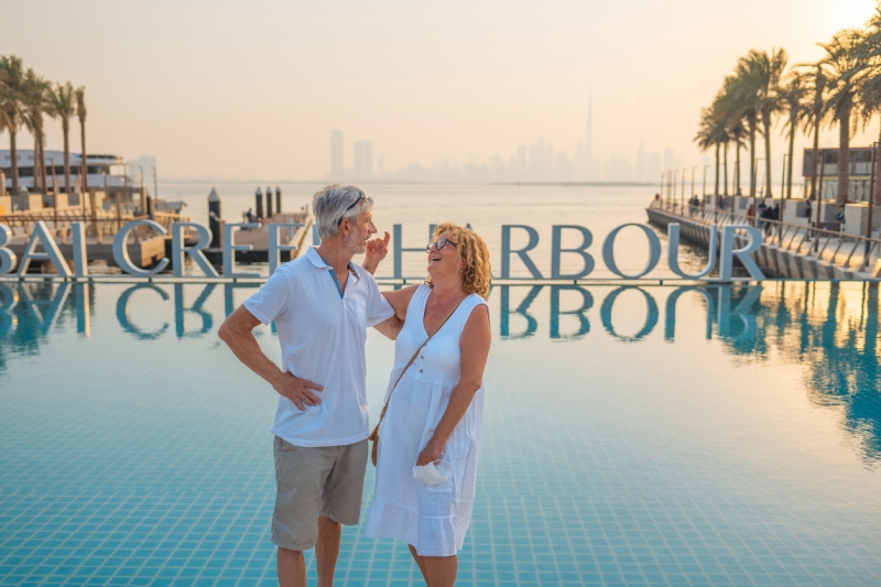 Couple enjoying Dubai Creek Harbour sunset view. Couple enjoying Dubai Creek Harbour sunset view.