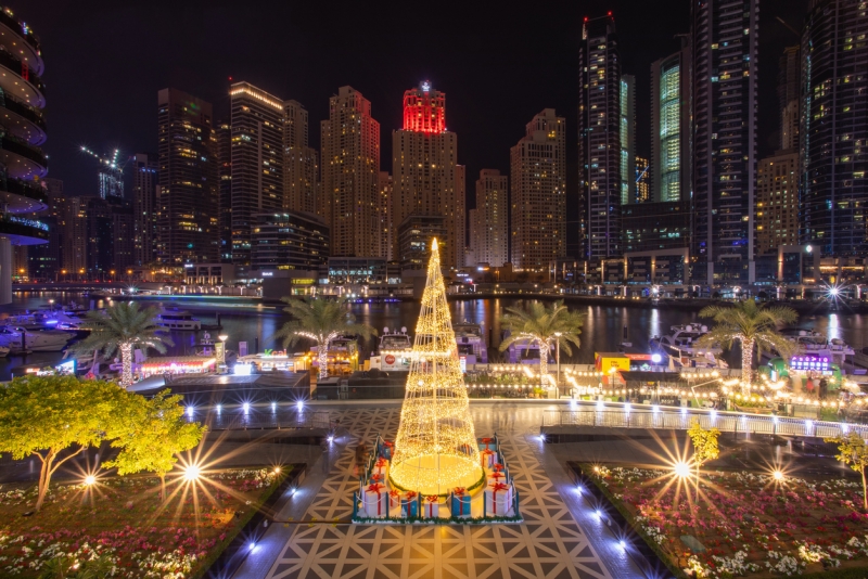 Shiny Christmas evening at the Dubai marina with lights shining from the beautiful tall buildings Shiny Christmas evening at the Dubai marina with lights shining from the beautiful tall buildings