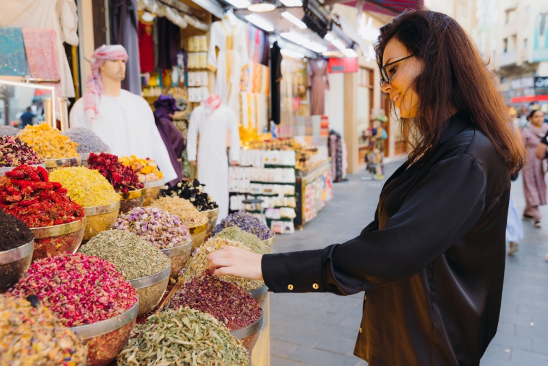 Woman Shopping at Spice and Dyes Market in Dubai City Woman Shopping at Spice and Dyes Market in Dubai City