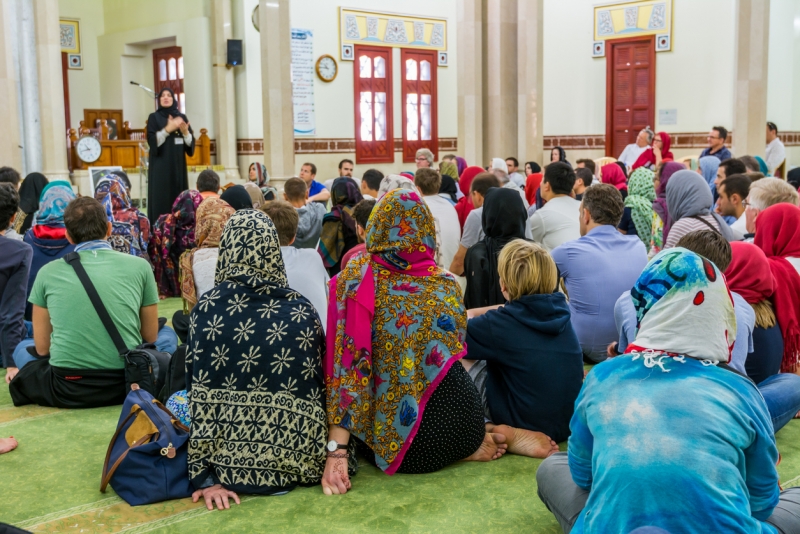 Non-Muslim guests listening a lecture from a Muslim female teacher inside of Jumeirah Mosque, the only mosque in Dubai which is open to the public and receiving non-Muslim guests Non-Muslim guests listening a lecture from a Muslim female teacher inside of Jumeirah Mosque, the only mosque in Dubai which is open to the public and receiving non-Muslim guests